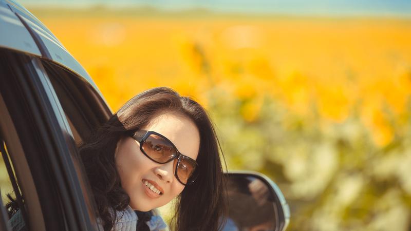 Portrait happy, smiling woman sitting in the car looking out windows.jpg