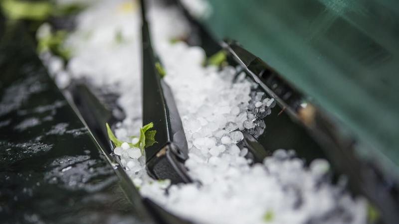 Hail building up on a car windshield