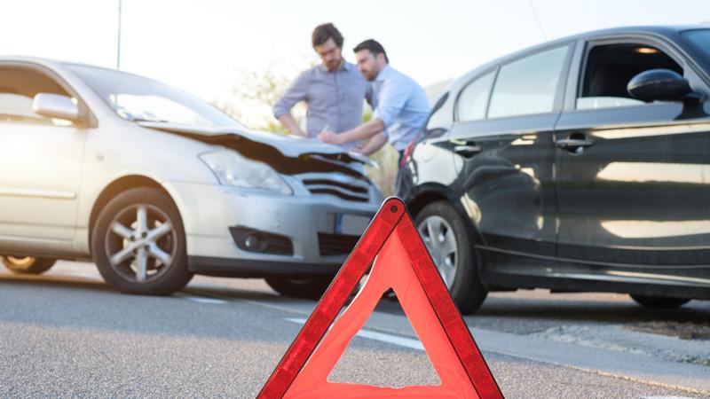 Two men swap contact details after a collision