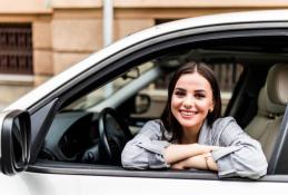 Portrait happy, smiling woman sitting in the car looking out windows.jpg