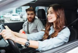 Portrait happy, smiling woman sitting in the car looking out windows.jpg