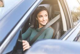 Portrait happy, smiling woman sitting in the car looking out windows.jpg