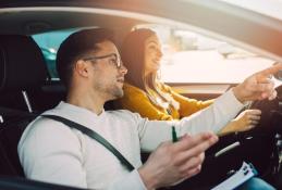 Portrait happy, smiling woman sitting in the car looking out windows.jpg