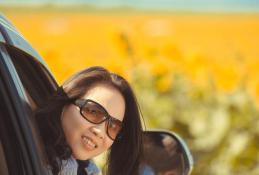 Portrait happy, smiling woman sitting in the car looking out windows.jpg