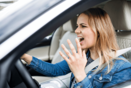 Portrait happy, smiling woman sitting in the car looking out windows.jpg