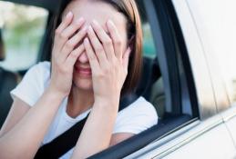 Portrait happy, smiling woman sitting in the car looking out windows.jpg