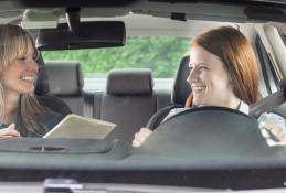 Portrait happy, smiling woman sitting in the car looking out windows.jpg