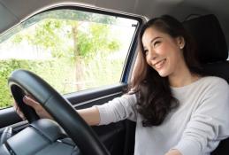 Portrait happy, smiling woman sitting in the car looking out windows.jpg