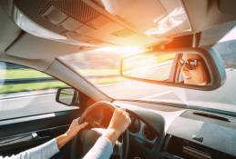 Portrait happy, smiling woman sitting in the car looking out windows.jpg