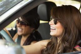 Portrait happy, smiling woman sitting in the car looking out windows.jpg