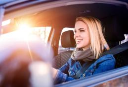 Portrait happy, smiling woman sitting in the car looking out windows.jpg